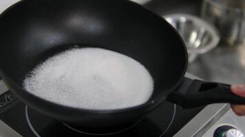 fry sugar Fast speed of sugar melts in a pan on gas fire and turns into caramel by stirring with a wooden spoon video