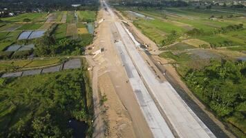 Aerial view of the construction of the highway in Central Java with rural area on the side. video