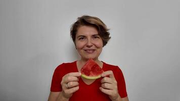 Smiling Caucasian woman holding a watermelon slice, symbolizing summer freshness and healthy eating video