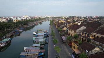 Aerial view of Hoi Ans historic riverside buildings and colorful boats, ideal for exploring Vietnamese culture and Lunar New Year celebrations video