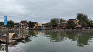 Scenic view of Hoi Ans riverside with colorful buildings and boats, ideal for travel and Lunar New Year themes video