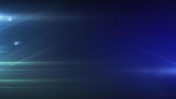 A blue light is shining on a dark background with lens flares video