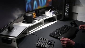 European man using ergonomic workplace equipment for login and using apps in two monitors setup to work from home office or as freelancer with modern technology setup and special devices for streaming video