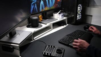 European man using ergonomic workplace equipment for login and using apps in two monitors setup to work from home office or as freelancer with modern technology setup and special devices for streaming video