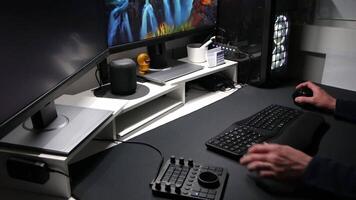 European man using ergonomic workplace equipment for login and using apps in two monitors setup to work from home office or as freelancer with modern technology setup and special devices for streaming video