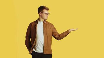 Man presenting something on yellow background video