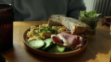 Delicious sandwiches with eggs, ham and cucumbers served on buffet table for brunch video