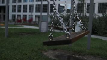 Empty playground after rain. Swing got wet in raindrops. Summer or spring rainy day. No people. No children. video