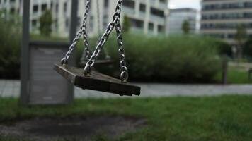 Empty playground after rain. Swing got wet in raindrops. Summer or spring rainy day. No people. No children. video