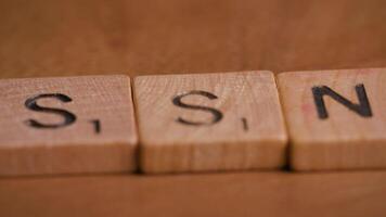 Dolly Move Over SSN Social Security Block Letters on Wooden Background video