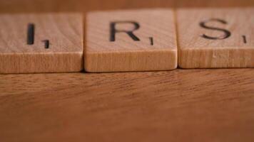 Dolly Move Over IRS Block Letters on Rustic Wooden Background for Tax Concept video