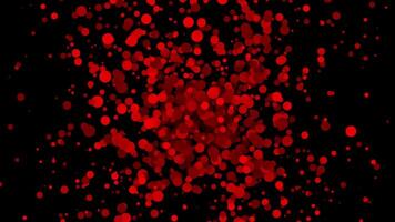 red slowly exploding particles on black background video