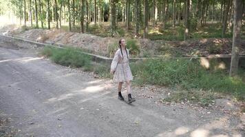 A Child Walking Along a Beautiful Forest Path Surrounded by Nature and Greenery video