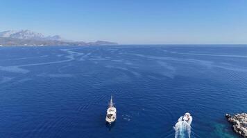 Drone Aerial of Yachts Moored by Island with Tourists Swimming on a Sunny Day video