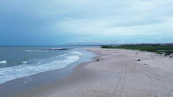 Aerial shot of a deserted beach on a cloudy day video
