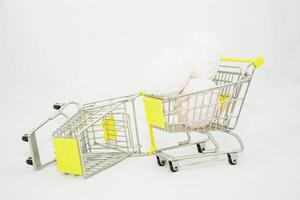 A toy shopping cart with a white and yellow umbrella photo