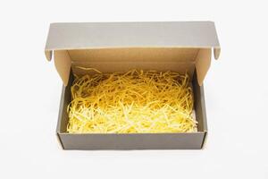 A box with yellow shredded cheese inside photo