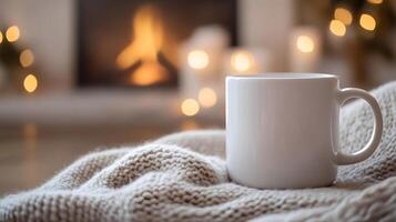 Blank White Mug on Knitted Fabric in Homey Setting with Fireplace Glow photo