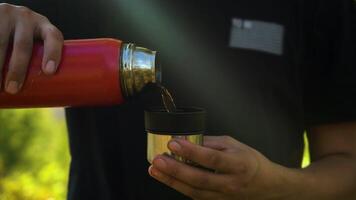 Pouring Tea From A Thermos Into A Cup video
