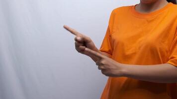 a woman is pointing to the left using both hands as if recommending something video