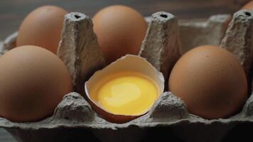 Fresh Chicken brown eggs in cardboard box on table. Slide shot. video