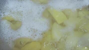 A pot of food is boiling with bubbles and foam. video