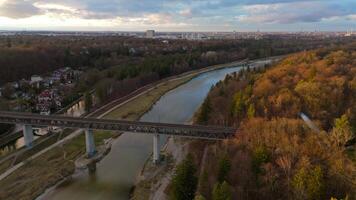 Grosshesseloher Brucke on Isar River in Munich, Germany aerial view. Two-story railroad and pedestrian bridge in Munchen over Isar River. Eisenbahnbrucke. Bike path runs under Railroad tracks. video