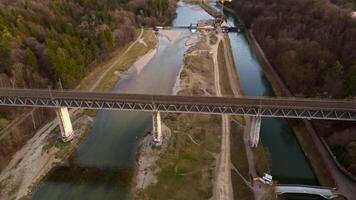 Grosshesseloher Brucke on Isar River in Munich, Germany aerial view. Two-story railroad and pedestrian bridge in Munchen over Isar River. Eisenbahnbrucke. Bike path runs under Railroad tracks. video
