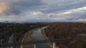 Grosshesseloher Brucke on Isar River in Munich, Germany aerial view. Two-story railroad and pedestrian bridge in Munchen over Isar River. Eisenbahnbrucke. Bike path runs under Railroad tracks. video