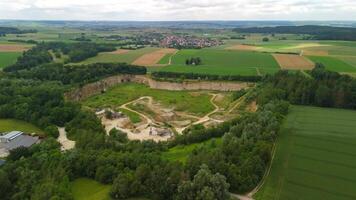 Aerial view of an abandoned mining quarry in Germany im Landkreis Dillingen. Open pit mines drone view. Steinbruch Luftaufnahme in Deutschland, Bayern in der Stadt Haunsheim. Mining equipment. video