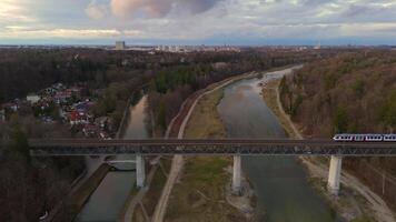 Grosshesseloher Brucke on Isar River in Munich, Germany aerial view. Two-story railroad and pedestrian bridge in Munchen over Isar River. Eisenbahnbrucke. Bike path runs under Railroad tracks. video