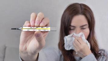 Looped animation of sick woman with thermometer and temperature 38 C close up video