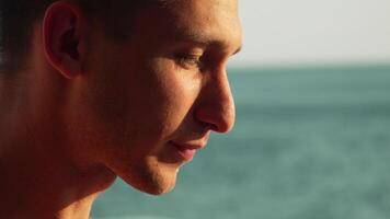 Man Ocean Beach Meditation - Calm male meditates while overlooking the ocean on a sunny day. video
