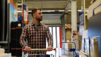 A customer with a trolley walking in a construction store video