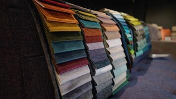 Fabric and textiles samples in a factory shop or store. Different colors and patterns on the market video