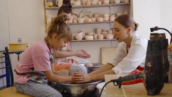 Kids learn pottery techniques in a fun art class in a bright studio video