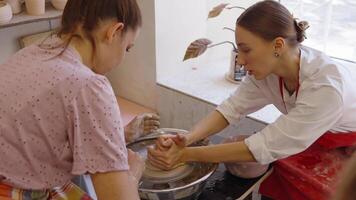 Learning pottery techniques in a studio setting during summer classes video