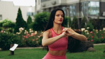 Fitness enthusiast demonstrates outdoor workout routine in a garden setting video