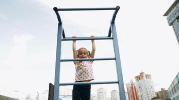 Child climbs playground structure in urban park during sunny afternoon video