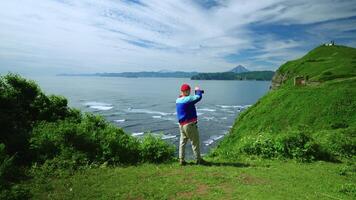 Trip To Mountains In Summertime, Man Standing Alone On Mount And Taking Photos Of Scenery, Rear View video