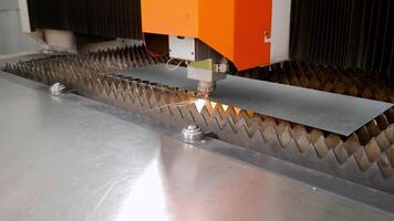 The high-tech automated metal-cutting machine, in operation, emits a cascade of scintillating sparks. video