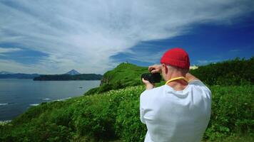 Man Taking Photo And Of Beautiful Nature Of Kamchatka Peninsula, Back View, Person With Camera video