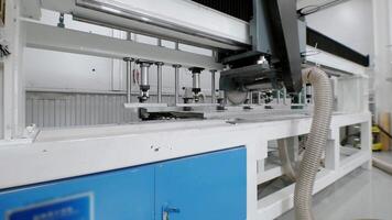 Operation of a numerically controlled circular metal saw in large-scale manufacturing. CNC video