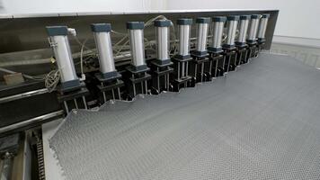 Terminal phase of operation of an assembly line machine, which produces composite metallic materials for interior wall structures in transportation vehicles. video
