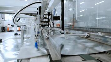 Mobile apparatus at factory organizes thin, lightweight metal sheets, stacking them one on top of other and sorting them. video