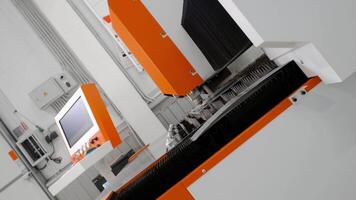 Operation of an electronic digitally controlled metal cutting machine has been started. The portable camera rotates and moves backwards. video