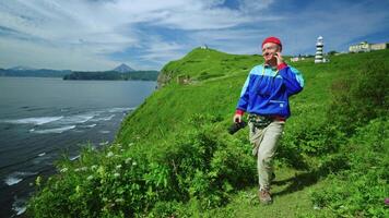 Joyful Hiker Walking Alone In Mountains On Ocean Shore In Summer, Photographing Natural Landscapes video