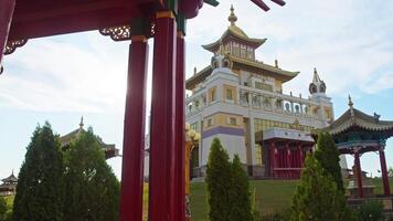 Front view of the largest Buddhist temple in Europe, standing on a hill, in the glare of the sun, is the Burkhan Bakshin Altan Sume. Slow motion video