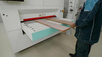 Process of automated bonding of composite panels for furniture and ceiling structures using high-capacity machine in manufacturing process. video