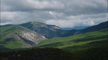 Beautiful natural mountain eco-friendly background. Timelapse of a beautiful mountain landscape and a cloudy sky above it. video